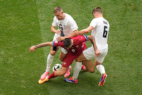 Serbia's Aleksandar Mitrovic fights for the ball